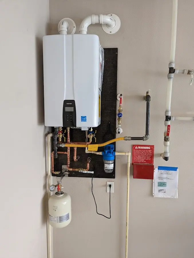 Professional plumber installing copper piping in a South Berwick home